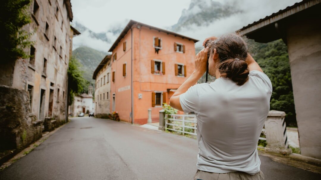 photographer with camera in village